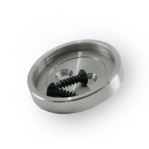 Circular chrome metal plate with an inner threaded rim and two black screws resting inside.
